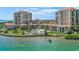 Beautiful community pool, lounge chairs and patio with a scenic waterfront view at 6322 Palma Del Mar S Blvd # 706, St Petersburg, FL 33715