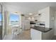 Well-lit kitchen features modern appliances, lots of storage, and adjacent breakfast nook with water views at 6322 Palma Del Mar S Blvd # 706, St Petersburg, FL 33715