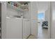 Laundry room with a white washer and dryer, shelves, and access to the bedroom at 6322 Palma Del Mar S Blvd # 706, St Petersburg, FL 33715