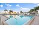 Inviting pool area with multiple lounge chairs and tiki huts, creating a resort-style atmosphere at 6322 Palma Del Mar S Blvd # 706, St Petersburg, FL 33715