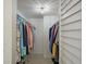 Bright walk-in closet with a variety of hanging clothes and a light fixture at 6322 Palma Del Mar S Blvd # 706, St Petersburg, FL 33715
