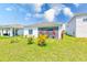Well-maintained backyard with healthy lawn and white exterior of the home at 6333 Milestone Loop, Palmetto, FL 34221