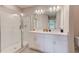 Bright bathroom featuring a double sink vanity and a glass-enclosed shower at 6333 Milestone Loop, Palmetto, FL 34221