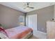 Neutral bedroom featuring a ceiling fan, a window, and closet space at 6333 Milestone Loop, Palmetto, FL 34221