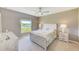 Comfortable bedroom featuring a light-colored wood bed frame and a view of the outside at 6333 Milestone Loop, Palmetto, FL 34221