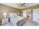 Cozy bedroom with a ceiling fan and a view into an attached bathroom at 6333 Milestone Loop, Palmetto, FL 34221