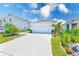 Charming one-story home with a well-manicured lawn and a spacious driveway under a bright blue, partly cloudy sky at 6333 Milestone Loop, Palmetto, FL 34221