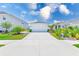 Charming one-story home with a well-manicured lawn and a spacious driveway under a bright blue, partly cloudy sky at 6333 Milestone Loop, Palmetto, FL 34221