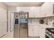 Well-lit kitchen featuring stainless steel appliances, ample white cabinetry, and a stylish tile backsplash for a modern touch at 6333 Milestone Loop, Palmetto, FL 34221