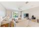 A bright living room features a comfortable sectional sofa and sliding glass doors to the outside at 6333 Milestone Loop, Palmetto, FL 34221