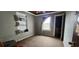This bedroom features built-in bookshelves, a window letting in light, and convenient access to a closet at 702 Whitehurst Rd, Plant City, FL 33563