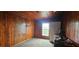 This cozy bedroom offers wood paneled walls and ceiling, a window and closet space for convenient storage at 702 Whitehurst Rd, Plant City, FL 33563