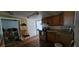 This kitchen boasts wooden cabinets, an oven, and good lighting, ready for Gathering meals at 702 Whitehurst Rd, Plant City, FL 33563