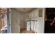 Functional laundry room with access to the exterior, a water heater, and storage cabinets at 702 Whitehurst Rd, Plant City, FL 33563