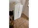 This room boasts a white cabinet and tiled floors, offering a practical storage solution at 702 Whitehurst Rd, Plant City, FL 33563