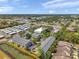 An aerial view highlighting townhomes, nearby conveniences, road access and surrounding greenery at 7070 Opal Dr, Largo, FL 33773