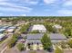 An aerial view of townhomes, showcasing their modern design, parking, and community setting surrounded by lush greenery at 7070 Opal Dr, Largo, FL 33773