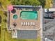 An aerial shot showcases the community pool and jacuzzi, surrounded by seating and meticulously maintained grounds at 7070 Opal Dr, Largo, FL 33773