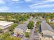 An aerial view showcasing townhome community, emphasizing the well-maintained grounds, parking areas and surrounding landscape at 7070 Opal Dr, Largo, FL 33773