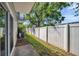 Charming backyard area featuring a well-maintained fence, lush greenery, and outdoor access at 7070 Opal Dr, Largo, FL 33773