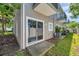 Nice backyard patio offering outdoor space, a sliding glass door, and a privacy fence at 7070 Opal Dr, Largo, FL 33773
