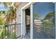 Step onto the balcony offering a view of the neighborhood's lush greenery and sky, a perfect spot for relaxing at 7070 Opal Dr, Largo, FL 33773