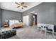 Large primary bedroom with a ceiling fan, spacious layout, and an attached desk area at 7070 Opal Dr, Largo, FL 33773