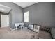 Bright bedroom showcasing a writing desk, comfortable sofa, and ample natural light through the window at 7070 Opal Dr, Largo, FL 33773