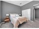 Comfortable bedroom featuring neutral tones, plush carpet, and closet with white doors at 7070 Opal Dr, Largo, FL 33773