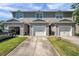 Townhome with attached garage, and well kept lawn offering a convenient and attractive living space at 7070 Opal Dr, Largo, FL 33773