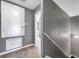 Hallway with gray carpet and walls leading to stairs with view to bathroom at 7070 Opal Dr, Largo, FL 33773