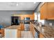 Well lit kitchen features granite countertops, an island, and stainless steel appliances at 7070 Opal Dr, Largo, FL 33773