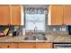 Kitchen features granite countertops, wooden cabinets, a stainless steel sink, and updated appliances at 7070 Opal Dr, Largo, FL 33773