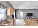 Well lit kitchen with granite countertops and stainless steel sink at 7070 Opal Dr, Largo, FL 33773