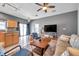 Open living room with a ceiling fan, sofa, and kitchen at 7070 Opal Dr, Largo, FL 33773