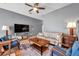 Cozy living room with hardwood floors, ceiling fan, and neutral wall color at 7070 Opal Dr, Largo, FL 33773