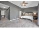 A bedroom with ceiling fan, closet, and view of hallway and doors at 7070 Opal Dr, Largo, FL 33773