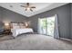 Spacious main bedroom featuring a ceiling fan and sliding glass doors to a balcony at 7070 Opal Dr, Largo, FL 33773