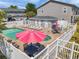 A view showcases the community pool and jacuzzi, surrounded by seating and meticulously maintained grounds at 7070 Opal Dr, Largo, FL 33773