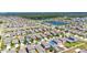 Birds-eye view of a home and the surrounding neighborhood, complete with a community lake at 7236 Salt River Ave, Sun City Center, FL 33573