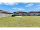 A backyard offering a well-manicured lawn, small patio, and privacy fence, great for entertaining or relaxing outdoors at 7236 Salt River Ave, Sun City Center, FL 33573