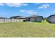 Spacious backyard with healthy green grass, small patio, and full perimeter fence offering privacy at 7236 Salt River Ave, Sun City Center, FL 33573