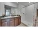 Bathroom featuring double granite vanity and a tile shower with glass door at 7236 Salt River Ave, Sun City Center, FL 33573