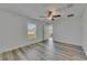 Well-lit bedroom with laminate flooring, a ceiling fan, and a window at 7236 Salt River Ave, Sun City Center, FL 33573