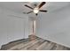 Bedroom featuring hardwood floors, a modern ceiling fan, a closet, and access to the bathroom at 7236 Salt River Ave, Sun City Center, FL 33573