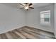 Bedroom featuring modern ceiling fan, hardwood floors, and a bright window for natural lighting at 7236 Salt River Ave, Sun City Center, FL 33573