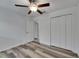 Bedroom featuring modern ceiling fan, hardwood floors, a closet, and access to the bathroom at 7236 Salt River Ave, Sun City Center, FL 33573