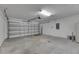 A spacious two car garage featuring white walls, a garage door, and concrete flooring at 7236 Salt River Ave, Sun City Center, FL 33573