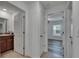 Hallway with doors to the bathroom, bedroom, and closet featuring modern neutral paint and flooring at 7236 Salt River Ave, Sun City Center, FL 33573