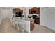 Stylish kitchen featuring a center island with stool seating, dark wood cabinetry, and modern fixtures at 7236 Salt River Ave, Sun City Center, FL 33573